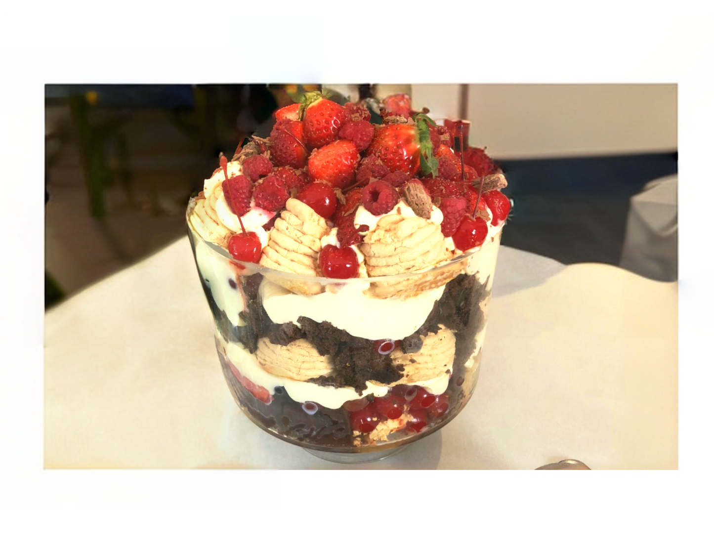 Chocolate pavlova trifle served in complimentary footed glass trifle bowl